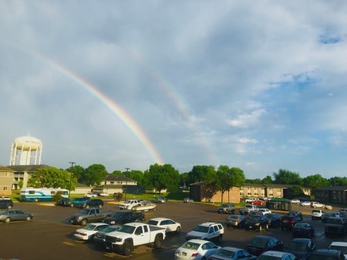 a rainbow over a parking lot