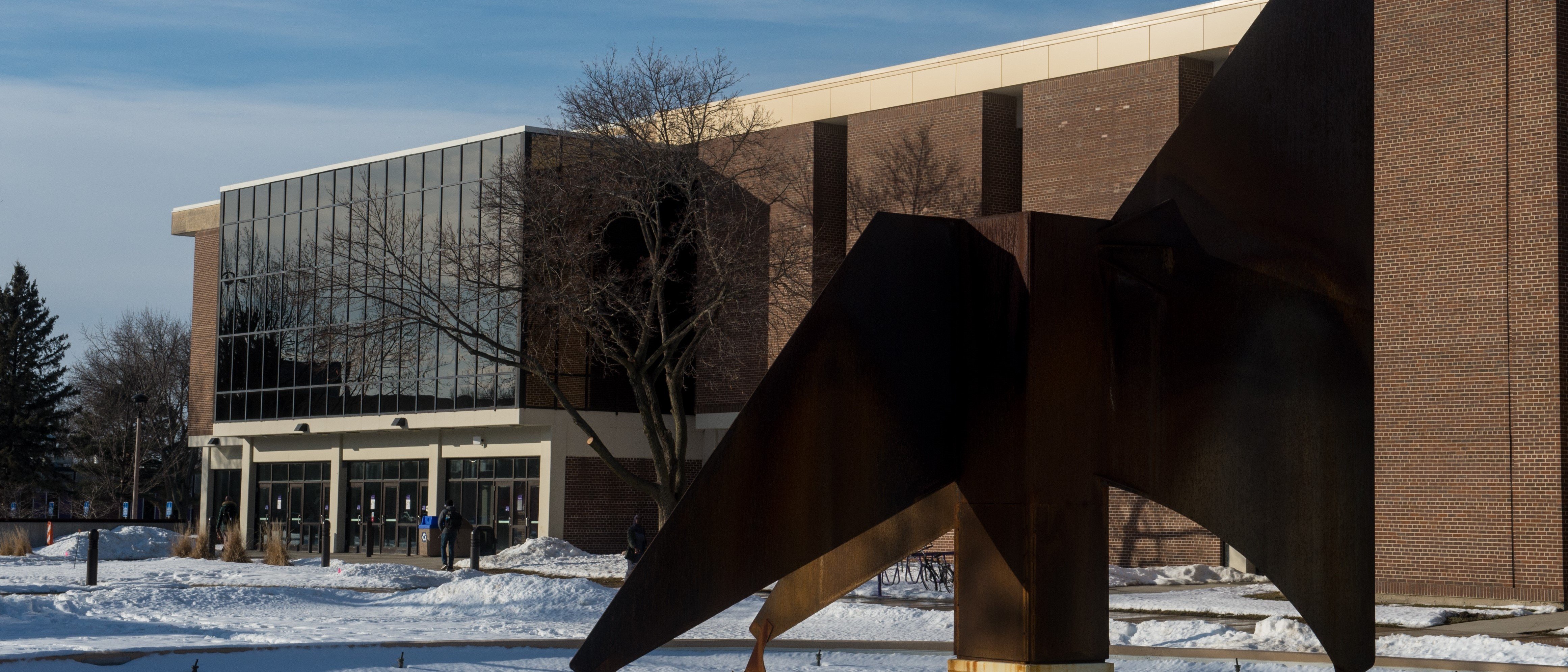 a large metal statue of an eagle in front of a building